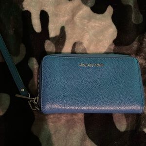 Navy blue Michael Kors wallet with wristlet strap.